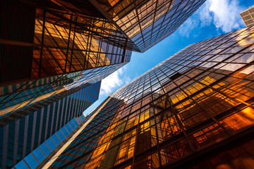 Fototapeta premium abstract perspective golden lighting on buildings and blue sky