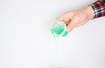 detergent measuring cup in hand