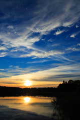 Fototapeta na wymiar Summer sunset lake landscape over the Wejsunek lake in Wejsuny in Masuria region in Poland