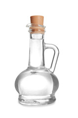 Glass jug with vinegar on white background