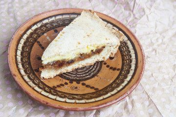 A piece of cake with fried onions and cheese. Candid.