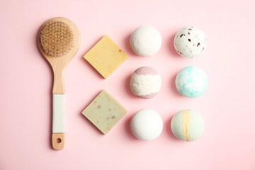 Flat lay composition with bath bombs, brush and soap bars on color background
