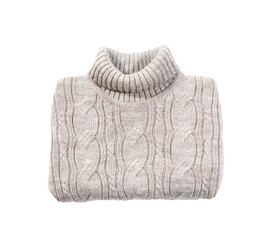 Folded cozy warm sweater on white background, top view