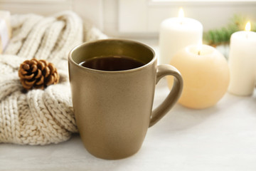 Composition with cup of hot winter drink on table. Cozy season