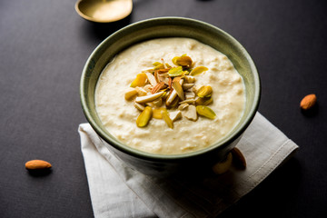 Sweet Rabdi or Lachha Rabri or basundi, made with pure milk garnished with dry fruits. Served in a bowl over moody background. Selective focus