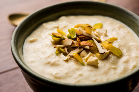 Sweet Rabdi or Lachha Rabri or basundi, made with pure milk garnished with dry fruits. Served in a bowl over moody background. Selective focus