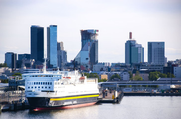 Big ferry in the port on the background of the modern city of Tallinn