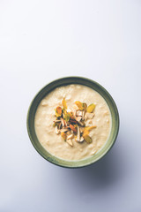 Sweet Rabdi or Lachha Rabri or basundi, made with pure milk garnished with dry fruits. Served in a bowl over moody background. Selective focus