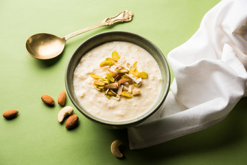 Sweet Rabdi or Lachha Rabri or basundi, made with pure milk garnished with dry fruits. Served in a bowl over moody background. Selective focus