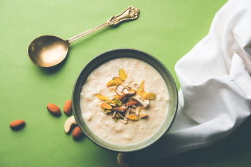 Sweet Rabdi or Lachha Rabri or basundi, made with pure milk garnished with dry fruits. Served in a bowl over moody background. Selective focus