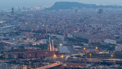 Barcelona and Badalona skyline with roofs of houses and sea on the horizon day to night timelapse
