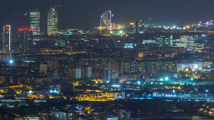 Naklejka premium Barcelona and Badalona skyline with roofs of houses and sea on the horizon night timelapse