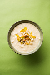 Sweet Rabdi or Lachha Rabri or basundi, made with pure milk garnished with dry fruits. Served in a bowl over moody background. Selective focus