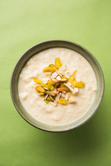 Sweet Rabdi or Lachha Rabri or basundi, made with pure milk garnished with dry fruits. Served in a bowl over moody background. Selective focus
