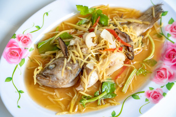Fish in soy sauce, served on white plate