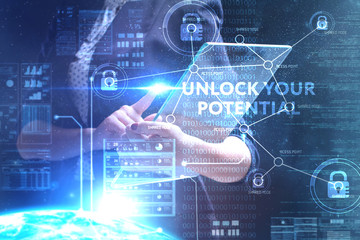 The concept of business, technology, the Internet and the network. A young entrepreneur working on a virtual screen of the future and sees the inscription: Unlock your potential