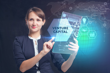 The concept of business, technology, the Internet and the network. A young entrepreneur working on a virtual screen of the future and sees the inscription: Venture capital