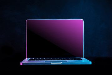 Portable modern silver computer on a black background.	