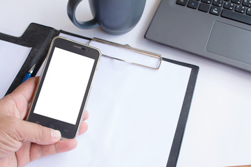 Asian man holding his blank smartphone during work in office