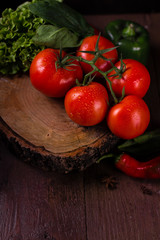 Fresh organic tomatoes on wooden background