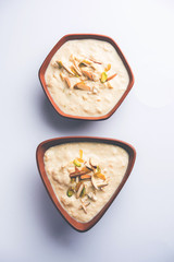 Sweet Rabdi or Lachha Rabri or basundi, made with pure milk garnished with dry fruits. Served in a bowl over moody background. Selective focus