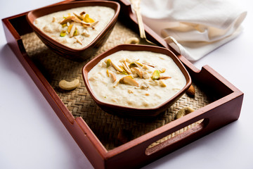 Sweet Rabdi or Lachha Rabri or basundi, made with pure milk garnished with dry fruits. Served in a bowl over moody background. Selective focus