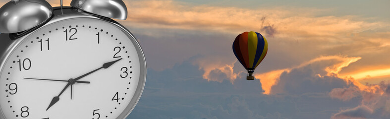 An alarm clock with a cloudy sunset in the background