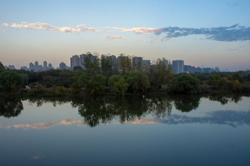 As the sun sets, the beautiful clouds and sky reflects on the calm waters of Wuhan, China on a atypical weather and pollution day. Gorgeous!