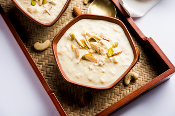 Sweet Rabdi or Lachha Rabri or basundi, made with pure milk garnished with dry fruits. Served in a bowl over moody background. Selective focus