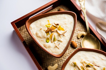 Sweet Rabdi or Lachha Rabri or basundi, made with pure milk garnished with dry fruits. Served in a bowl over moody background. Selective focus
