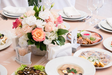Served for banquet restaurant table with dishes, snack, cutlery, wine and water glasses, european food, selective focus