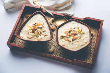 Sweet Rabdi or Lachha Rabri or basundi, made with pure milk garnished with dry fruits. Served in a bowl over moody background. Selective focus