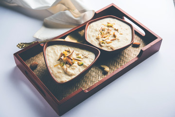 Sweet Rabdi or Lachha Rabri or basundi, made with pure milk garnished with dry fruits. Served in a bowl over moody background. Selective focus