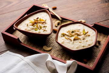 Sweet Rabdi or Lachha Rabri or basundi, made with pure milk garnished with dry fruits. Served in a bowl over moody background. Selective focus