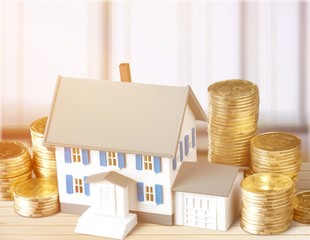Model of house with coins on  table