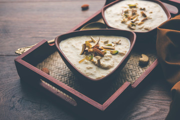 Sweet Rabdi or Lachha Rabri or basundi, made with pure milk garnished with dry fruits. Served in a bowl over moody background. Selective focus