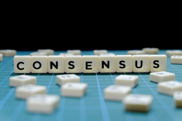 Selective focus of Consensus word made of square letter block on green square mat background. - obrazy, fototapety, plakaty