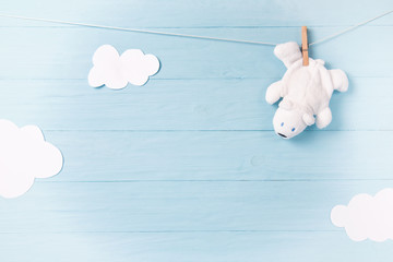 Baby boy background with white teddy bear toy on a clothesline and clouds
