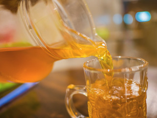 Close up Pour tea into a glass