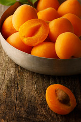 Ripe apricots on the wooden background.