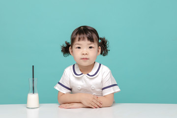 Little pretty Asian girl laughing portrait with milk and bread, healthy and happy lifestyle.