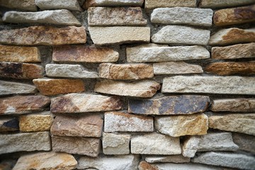 Natural stone flagstone, laid in uneven rows. Background of the flagstone