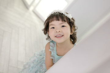 Little pretty Asian girl dressing as princess laughing portrait, healthy and happy lifestyle.