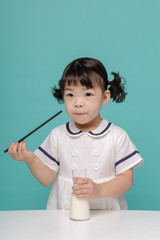 Little pretty Asian girl laughing portrait with milk and bread, healthy and happy lifestyle.