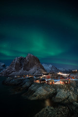 Fisherman village with Aurora in the background travel concept world explore northern light / Lofoten Norway