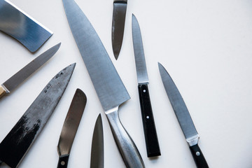 A variety of knives on a plain background. Knife crime concept