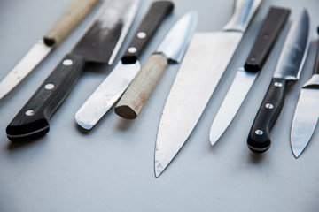 A variety of knives on a plain background. Knife crime concept