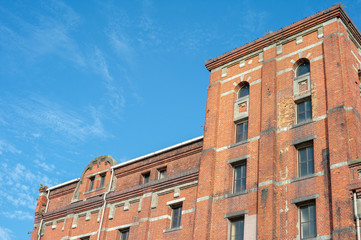Perspective of old orange bricklayers building in the sunny day