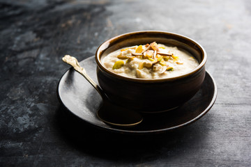 Sweet Rabdi or Lachha Rabri or basundi, made with pure milk garnished with dry fruits. Served in a bowl over moody background. Selective focus