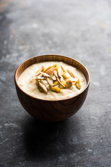 Sweet Rabdi or Lachha Rabri or basundi, made with pure milk garnished with dry fruits. Served in a bowl over moody background. Selective focus